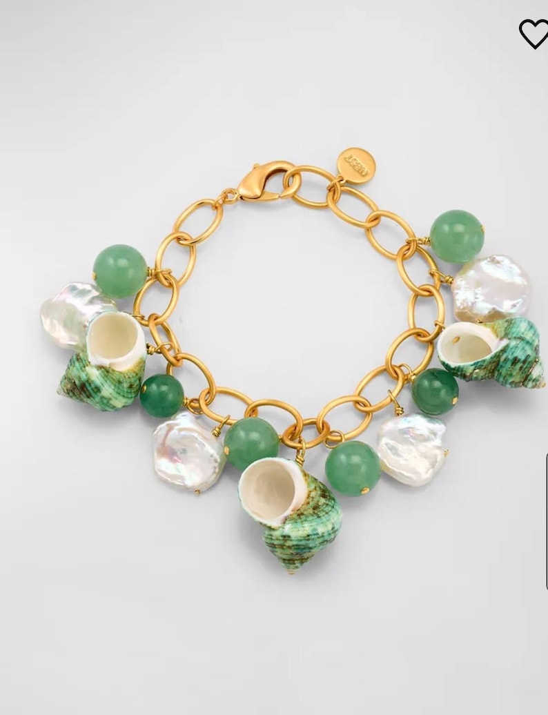 May include: Gold-toned bracelet featuring a chain design with green beads, white pearls, and green and white seashells. The bracelet has a lobster clasp closure and a small charm.