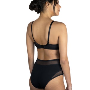 May include: Black lingerie set with a high-waisted bottom and a lace bra. The bottom has a mesh panel on the side.