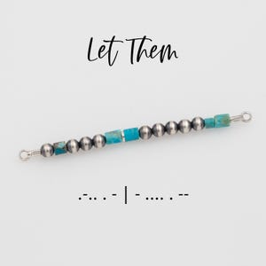 May include: A beaded bracelet with silver-colored beads and turquoise-colored square beads. The bracelet has a delicate design and is strung on a wire. The words "Let Them" are written in cursive above the bracelet, and Morse code is written below.