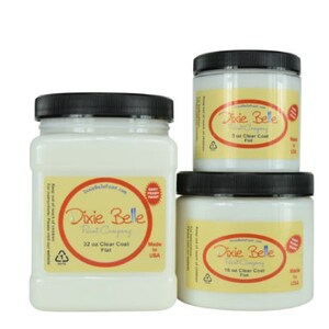 May include: Three white paint jars with black lids. The jars are labeled "Dixie Belle Paint Company" and contain different sizes of clear coat paint: 32 oz, 16 oz, and 3 oz. The jars are made in the USA.