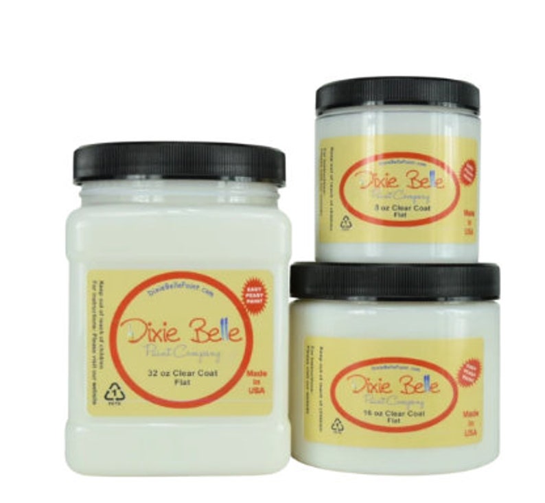 May include: Three white paint jars with black lids. The jars are labeled "Dixie Belle Paint Company" and contain different sizes of clear coat paint: 32 oz, 16 oz, and 3 oz. The jars are made in the USA.