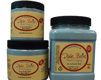 May include: Three jars of Dixie Belle Paint Company chalk mineral paint in the color Dusty Blue. The jars are 8 ounces, 16 ounces, and 32 ounces. The paint is zero VOC's and made in the USA.