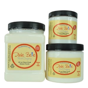 May include: Three white jars of Dixie Belle Paint Company clear coat in gloss finish. The jars are labeled with the size in ounces: 8 oz, 16 oz, and 32 oz. All jars are made in the USA.