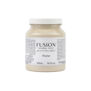 May include: A 16.9 fluid ounce bottle of Fusion Mineral Paint in the color Plaster. The bottle is white with a black label and the text "Fusion Mineral Paint paint it beautiful" and "Plaster".