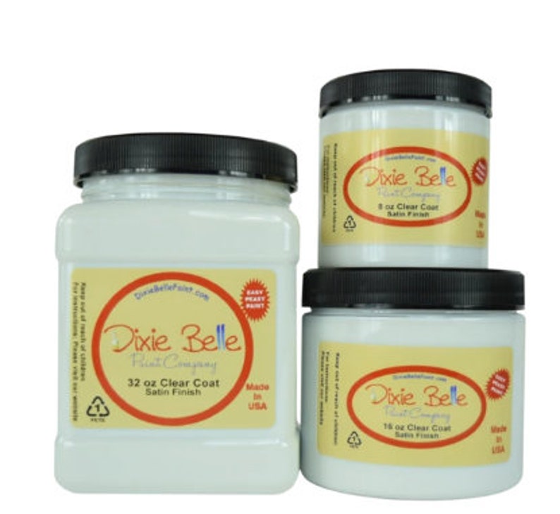 May include: Three white plastic jars of Dixie Belle Paint Company clear coat in satin finish. The jars are labeled with the size in ounces: 32 oz, 16 oz, and 8 oz.  The jars are made in the USA.