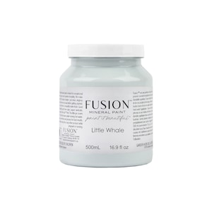 May include: A 16.9 fluid ounce bottle of Fusion Mineral Paint in the color Little Whale. The paint is a light blue color and is labeled with the Fusion logo and the words "paint it beautiful".