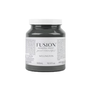 May include: A 500ml bottle of Fusion Mineral Paint in the colour Wellington. The paint is a dark grey colour and the bottle is labelled with the Fusion logo and the name of the colour.