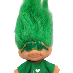 May include: A vintage troll doll with bright green hair and green-tinted glasses. The doll wears a green shirt with the text "I ♥ THE IRISH" in white. The troll has a tan skin tone and is posed against a white background.