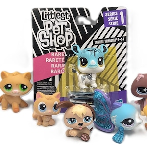 May include: A collection of Littlest Pet Shop figurines, including a giraffe, monkey, cat, and dog. The toys are in various colors, with large, expressive eyes. The packaging includes the text "Littlest Pet Shop" and "Series 1".