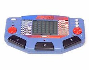 Vintage 1995 Tiger Electronics Jeopardy Handheld Trivia Game System Complete with book and cartridge