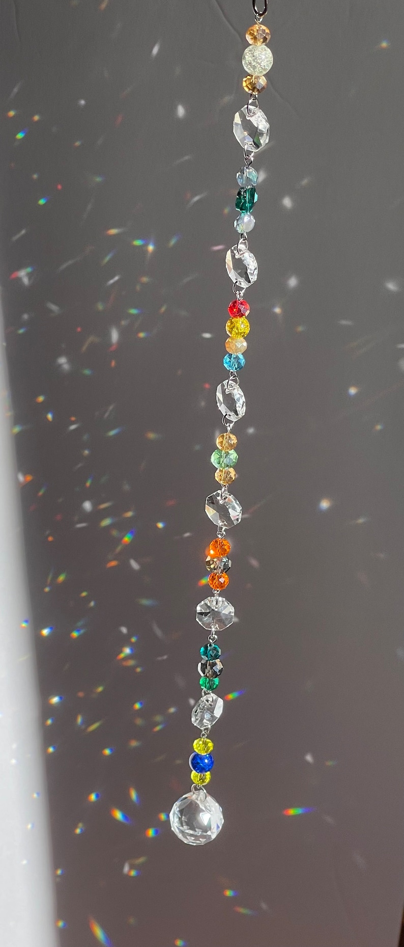 Single strand showing the 1 inch prism ball and the rainbows it casts in the sun