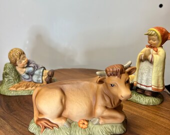 The 1996 Berta Hummel Nativity 33517 Sleeping shepherd, Peasant girl, and ox.