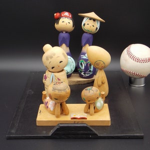 Collection of Traditional Japanese Kokeshi Dolls on Wooden Tray