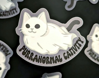 May include: A set of six stickers featuring a white cat ghost with the text "Purr-a-normal Gativity" in a black, cursive font. The stickers are printed on a clear, glossy background.