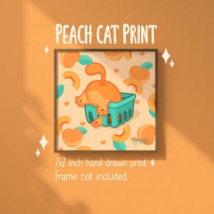 May include: A framed 17.78 x 17.78 cm hand-drawn print titled "Peach Cat Print." The artwork features a cartoon cat with its rear end in a teal basket, surrounded by peaches and hearts on a light peach background.
