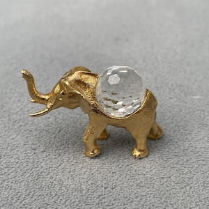 Gold metal Elephant set with faceted glass globe