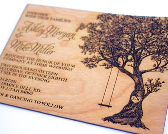 May include: Laser-cut wooden wedding invitation with a tree and swing design. The invitation reads "Ashley Morgan & Mike Miller request the honor of your company at their wedding two thousand sixteen Saturday, October eighth at six in the evening Le Jardin 1910 Dimple Dell Rd. Sandy, Utah 84092 Dinner & Dancing to follow".