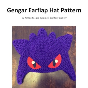 May include: Purple crochet Gengar earflap hat pattern with red felt eyes. Difficulty: Easy.