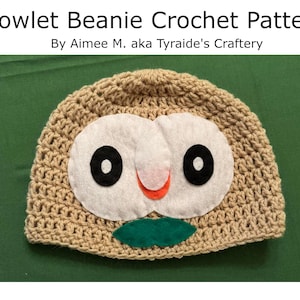 May include: A tan crocheted beanie featuring a felt owl face with black eyes, a pink and orange beak, and a green leaf. The text "Rowlet Beanie Crochet Pattern" is at the top.