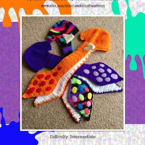 May include: A collection of handmade crochet Inkling hats in various colors, including orange, purple, and black. The hats feature unique designs and are displayed on a neutral surface. The text on the image says "Inkling Hat ('Female Style')".
