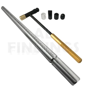 May include: A silver ring mandrel with a gold-colored handle and a black hammer with a gold-colored head. The mandrel is marked with ring sizes in both numbers and letters. The hammer has a black rubber head. The set includes a clear plastic ring sizer, a black rubber ring sizer, and a black rubber ring sizer.
