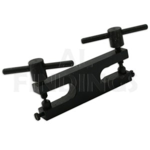 May include: Black metal tool with two adjustable handles and two circular openings. The tool is used for making jewelry.
