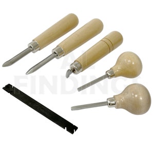 May include: Set of five metal and wood tools for jewellery making. The tools have wooden handles and metal tips with different shapes. There is also a black metal tool with a serrated edge.