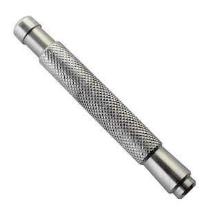 May include: A silver metal tool with a textured grip and a pointed tip. The tool is used for pushing out watch pins.