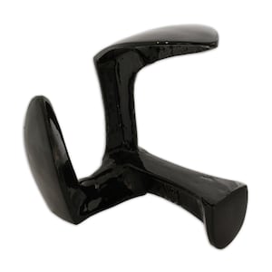 May include: A black, cast iron cobbler's last, used for shaping shoes. The tool has a curved, ergonomic design with a smooth, glossy finish. It is designed to support the shoe during the repair or construction process.