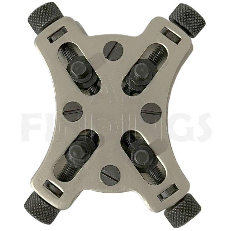 May include: A silver watch case holder with four adjustable arms. Each arm has a black knob and a screw to secure the watch case.