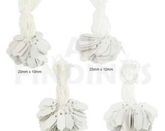 May include: Four bundles of white paper tags with string attached. The tags are in four different sizes: 20mm x 10mm, 25mm x 12mm, 25mm x 10mm, and 30mm x 15mm.