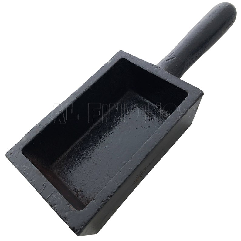 May include: Black cast iron ingot mold with a handle. The mold is rectangular and has a smooth, shiny surface.