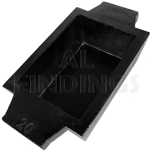 May include: Black metal casting mold with a rectangular cavity and a number "20" on the side. The mold is designed for casting metal bars or ingots.