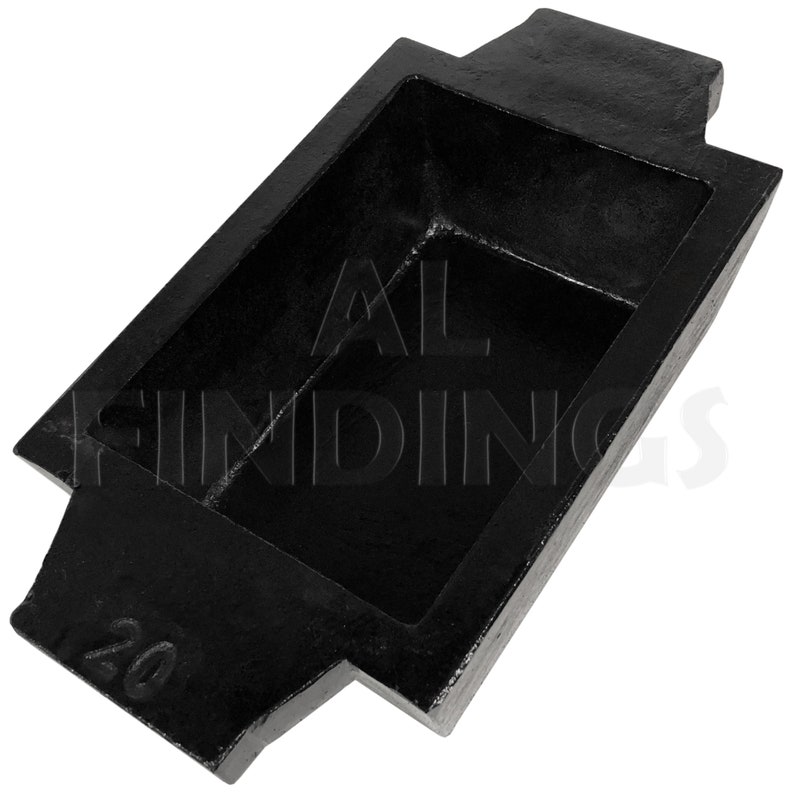 May include: Black metal casting mold with a rectangular cavity and a number "20" on the side. The mold is designed for casting metal bars or ingots.