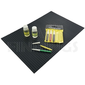 May include: A set of five oil painting tools with a black and yellow striped mat, two small bottles of oil, and three tools with white tips and green, yellow, and red handles. The packaging for the tools is yellow with the text "Oil Pin Set of Five".