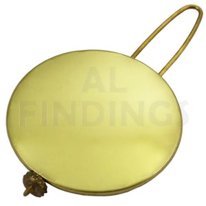 May include: A brass clock pendulum with a round, flat weight and a wire loop for hanging. The weight is engraved with the text "AL FINDINGS".