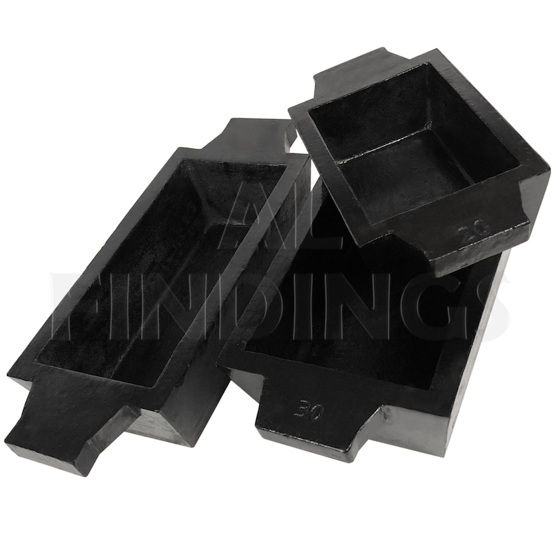 May include: Three black metal casting molds, stacked on top of each other. The molds are rectangular with a lip around the top edge. The molds are labeled with the numbers 30 and 25.