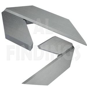 May include: A set of three metal angle gauges, each with a different angle. The gauges are made of silver-coloured metal and have a smooth, polished finish.