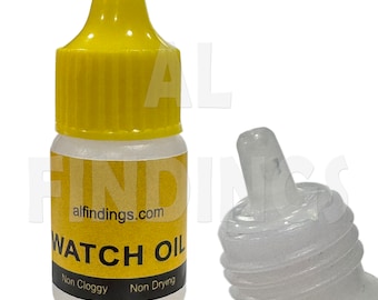 May include: A small clear bottle with a yellow cap, labeled "WATCH OIL" with the text "Non Cloggy" and "Non Drying" below. The bottle is filled with a clear liquid and has a dropper tip.