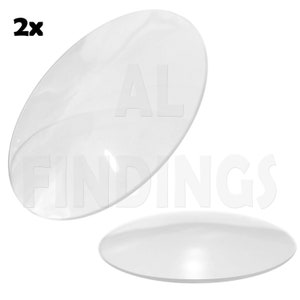 Op de afbeelding: Twee heldere, ovaalvormige, transparante plastic componenten. De tekst "2x" staat in de linkerbovenhoek. Het watermerk "AL FINDINGS" is zichtbaar op de achtergrond.