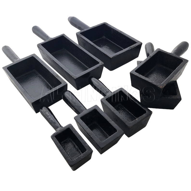 May include: Set of six black metal casting molds with handles. The molds are rectangular and come in various sizes.