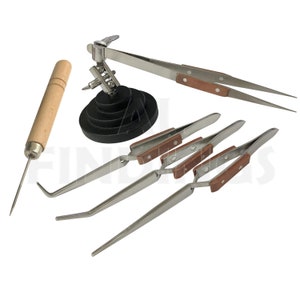 May include: A set of five soldering tools with wooden handles. The tools include a soldering iron holder, a pair of tweezers, and three different types of tweezers.
