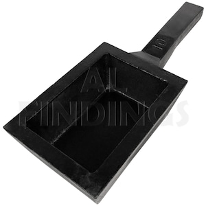May include: Black cast iron ingot mold with a handle. The mold has a rectangular shape with a 10 inscription on the handle.