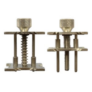 May include: Two metal watch band tools with adjustable screws and springs. The tools are used to remove and install watch bands.