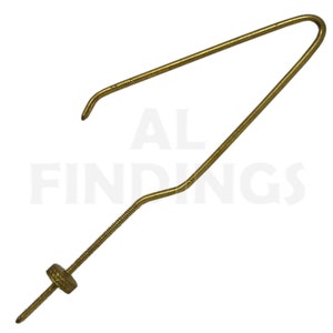May include: A gold-colored metal hook with a screw thread and a small knob at the end. The hook is bent into a V-shape.