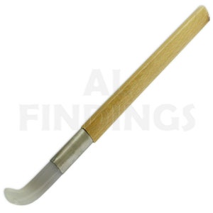 May include: A craft tool featuring a light wood handle and a curved, translucent tip. The handle is joined to the tip with a silver metal band. The tool is designed for detailed work and is set against a white background.