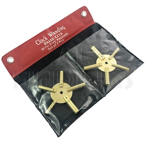 May include: Set of two brass clock winding keys with five prongs each. The keys are in a red and black pouch with the text "Clock Winding Brass Keys with Five Prongs Set of 2 Pcs."