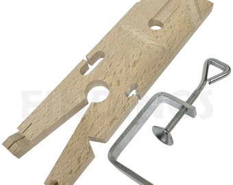 May include: A wooden ring mandrel with a metal clamp. The mandrel has two holes for different ring sizes. The clamp has a screw to tighten it.