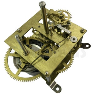 May include: A brass clockwork mechanism with a series of gears and a spring. The mechanism is mounted on a brass plate with a label that reads "10 DAY 8 DAY SYSTEM".
