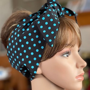 Peut inclure: Un foulard noir &agrave; pois bleu clair. Le foulard est nou&eacute; en n&oelig;ud sur le dessus de la t&ecirc;te. Le couvre-chef est sur une t&ecirc;te de mannequin.